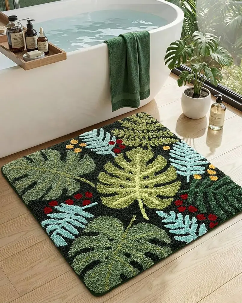 Colorful leaf-patterned bath mat placed on a wooden floor near a bathtub.