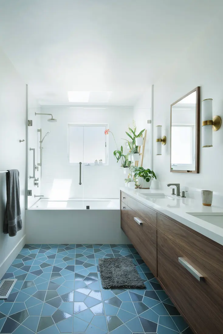 Modern bathroom featuring a shower and bath combination with a glass screen and shower curtain.