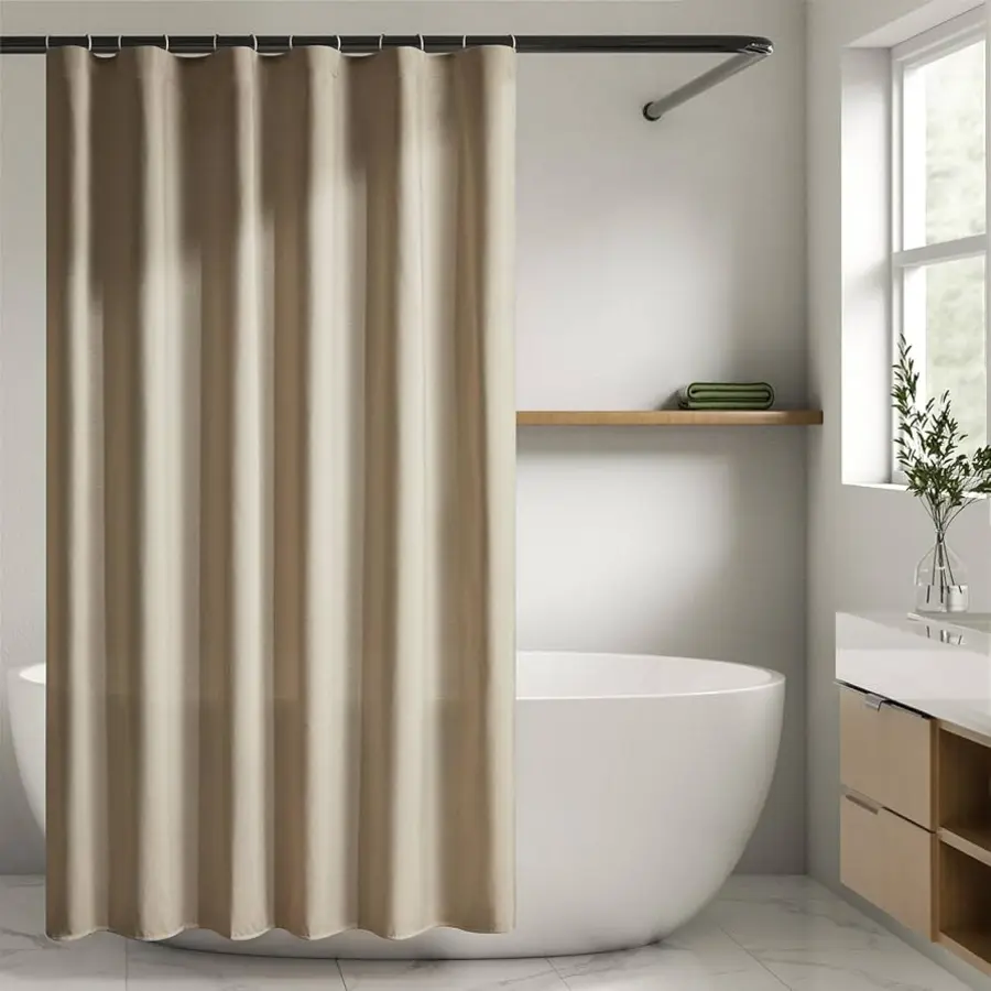 A beige shower curtain hanging from rings on a rod in a modern bathroom.