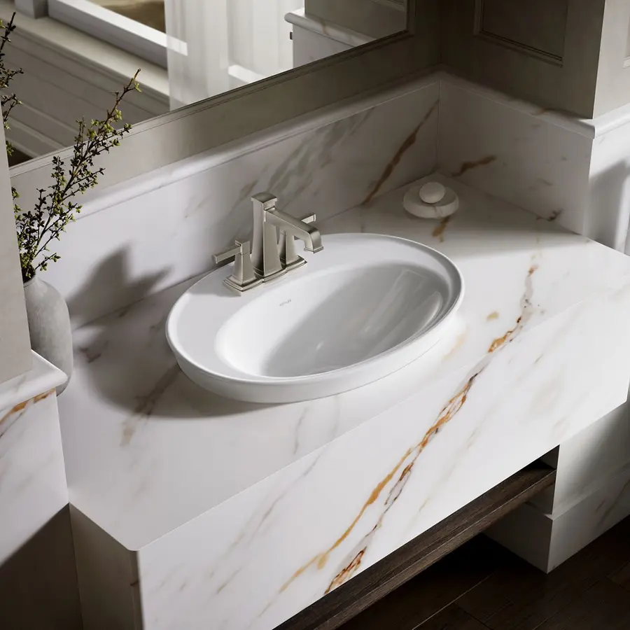 Clean bathroom sink with a white basin, metallic faucet, and visible overflow opening.