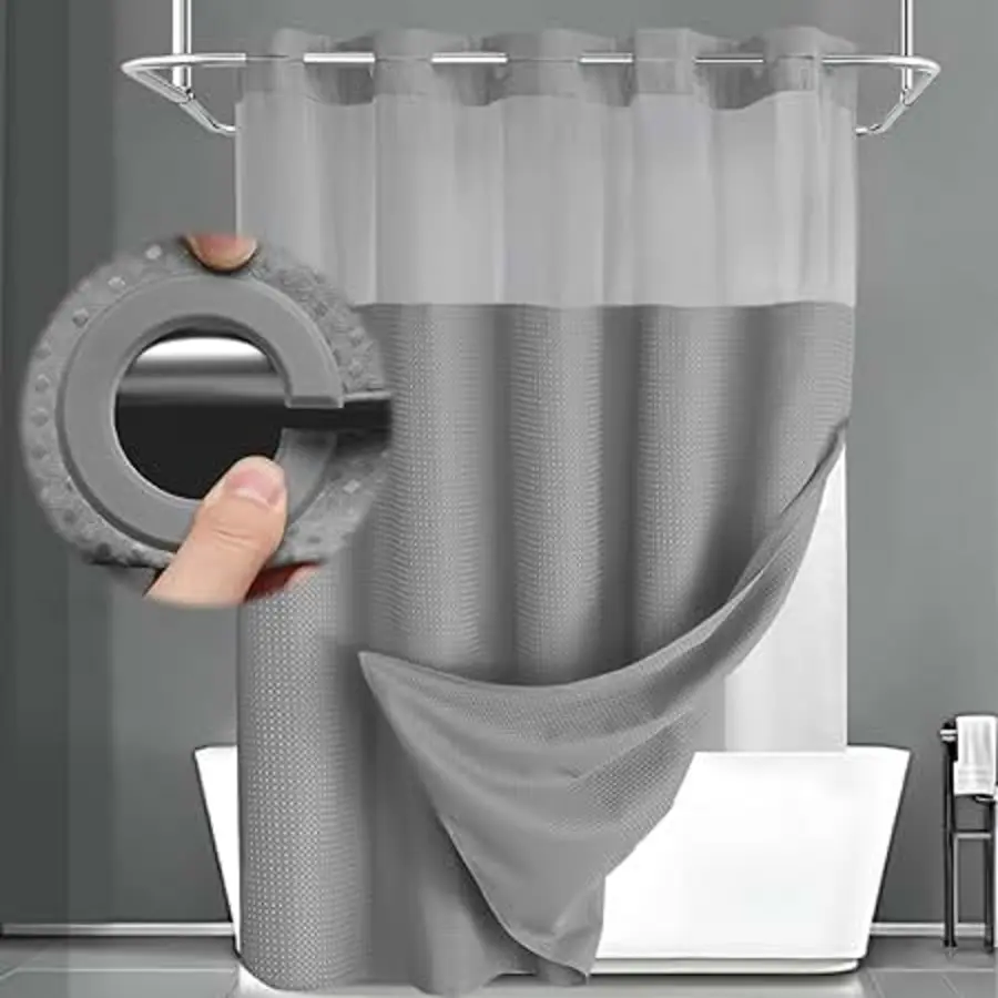 Shower curtain with a gray textured pattern and cleaning tool nearby.