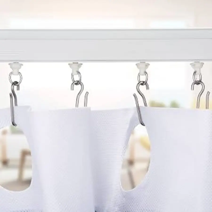 Shower curtain hooks attached to a track with visible fabric sections.