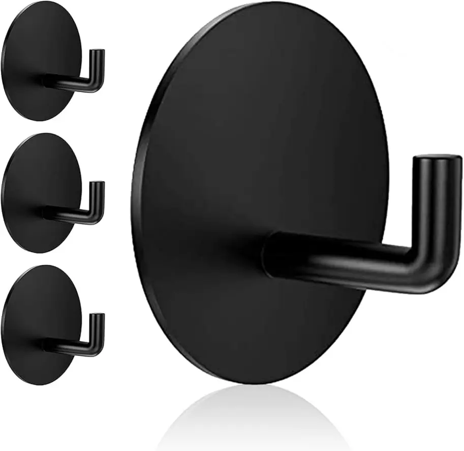 Four black wall hooks with a circular base and a vertical arm.