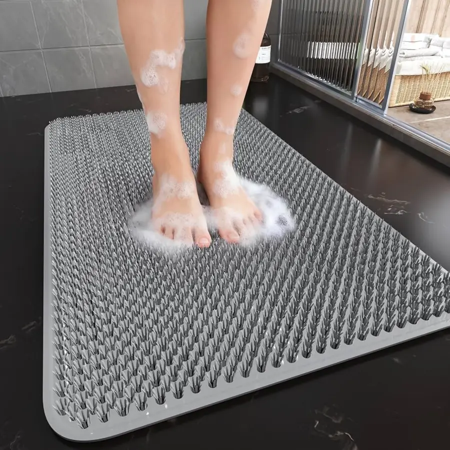 Feet covered in bubbles on a textured silicone shower mat.