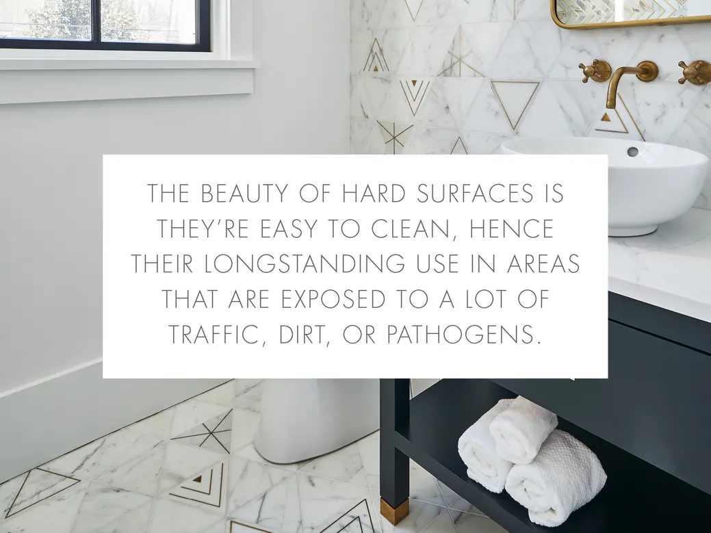 A bathroom scene with marble flooring, towel storage, and a sink area.