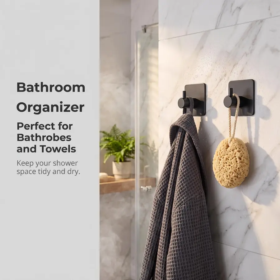 Bathroom with two black towel hooks on marble wall displaying a robe and a sponge.