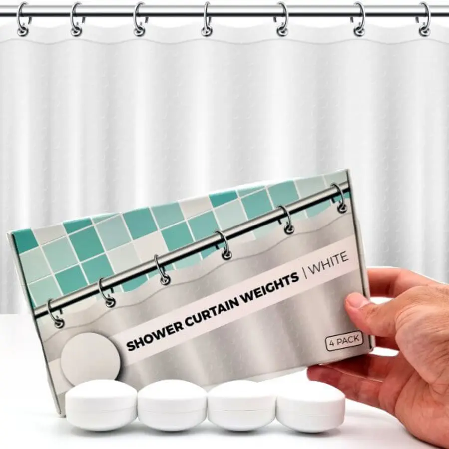 A hand holding a box of white shower curtain weights with three weights visible below.