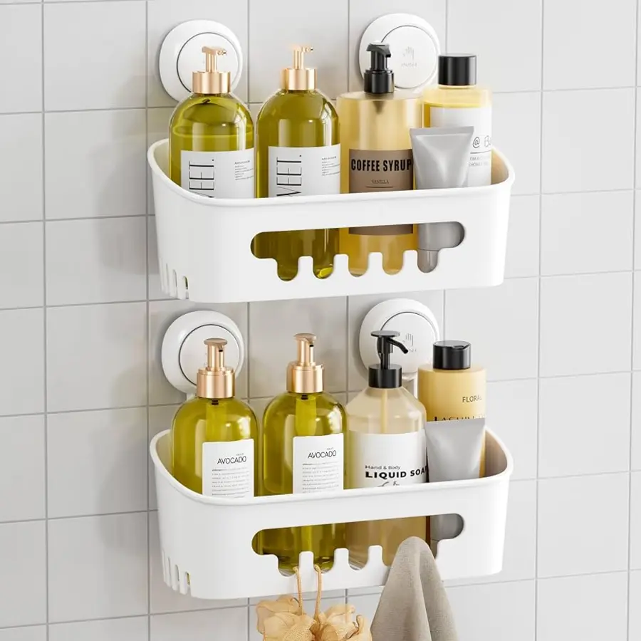 Two white shower caddies mounted on a tiled wall, holding various bottles and a towel.