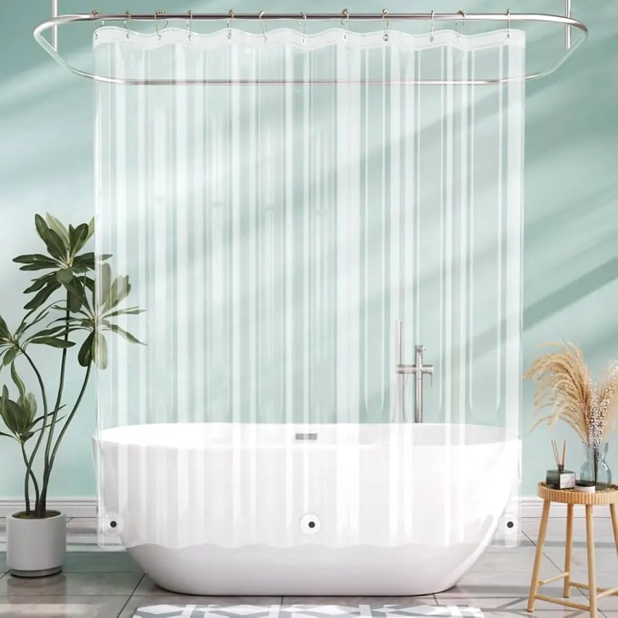 Clear shower curtain liner partially pulled away from a white bathtub, with plants in the background.