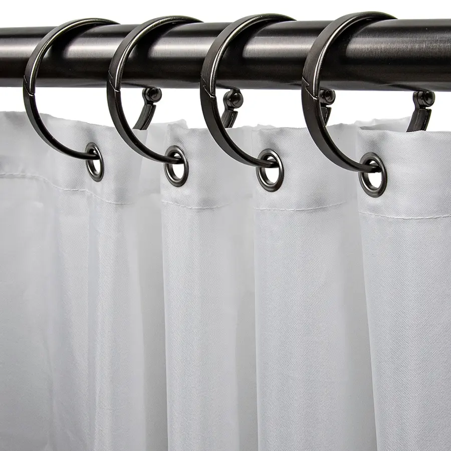 White shower curtain with metal rings hanging from a black rod.