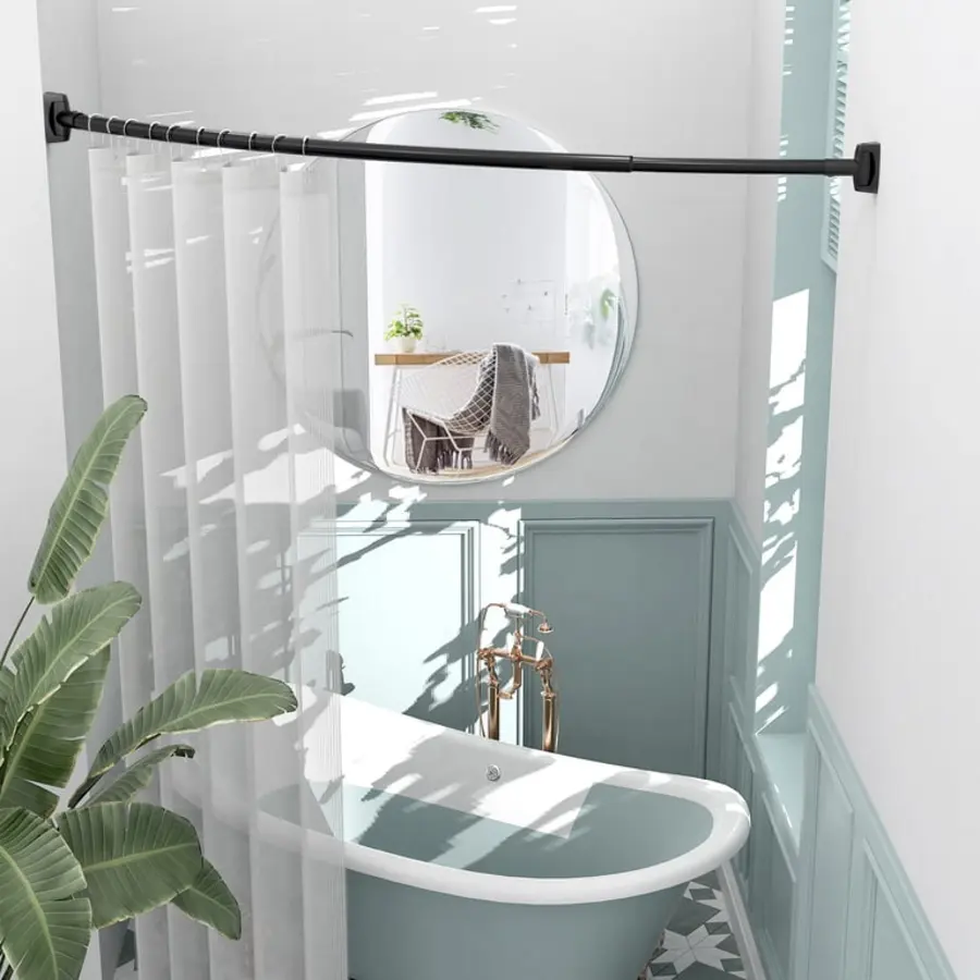 Curved shower rod with sheer curtains, bathtub, and round mirror in a modern bathroom setting.