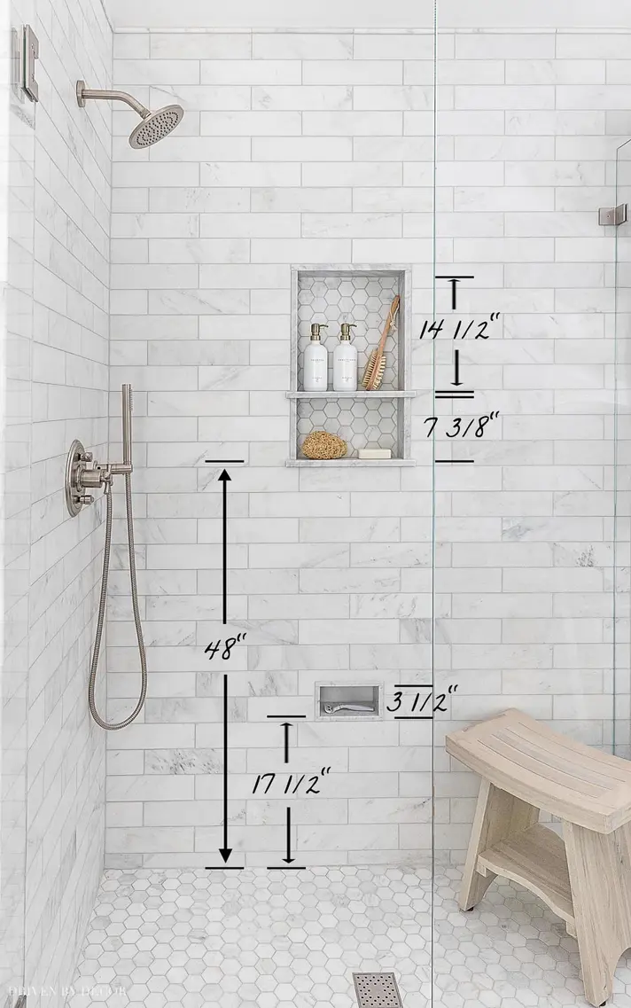 Shower area with tile walls, dimensions marked, featuring a wall-mounted showerhead and niche shelf.